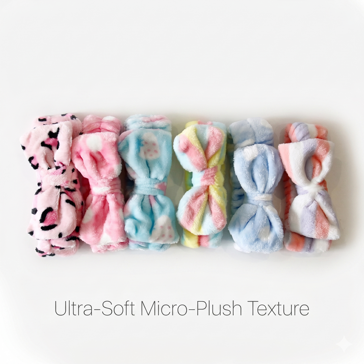 Assorted coral fleece bow headbands highlighting ultra-soft micro-plush material