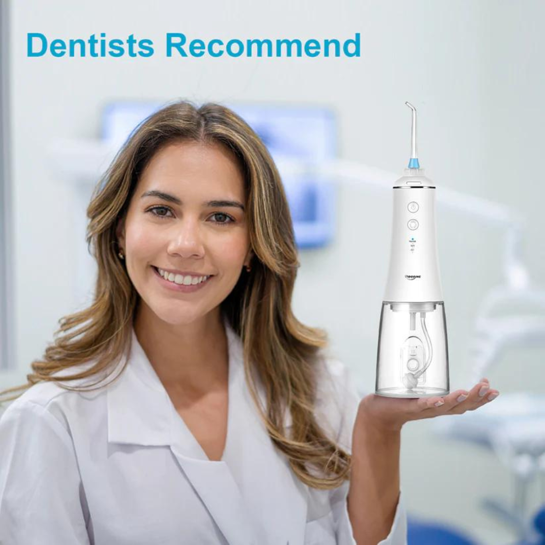 Dentist holding Cordless Water Flosser and smiling in a clinic setting. The product is presented as recommended for oral care.