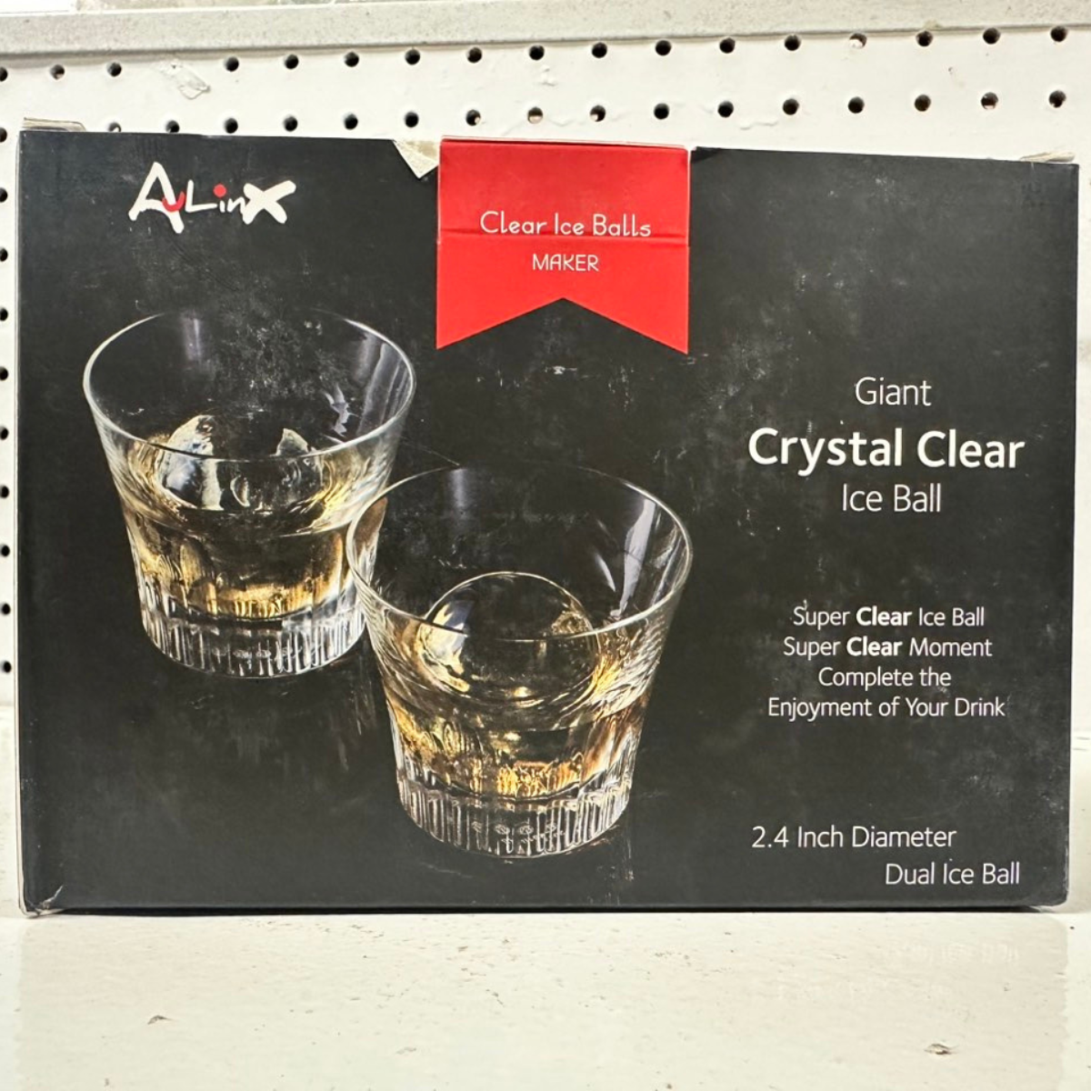 Crystal Clear Ice Ball Maker retail box with images of drinks and clear ice balls. The packaging shows product features and ice ball size details.