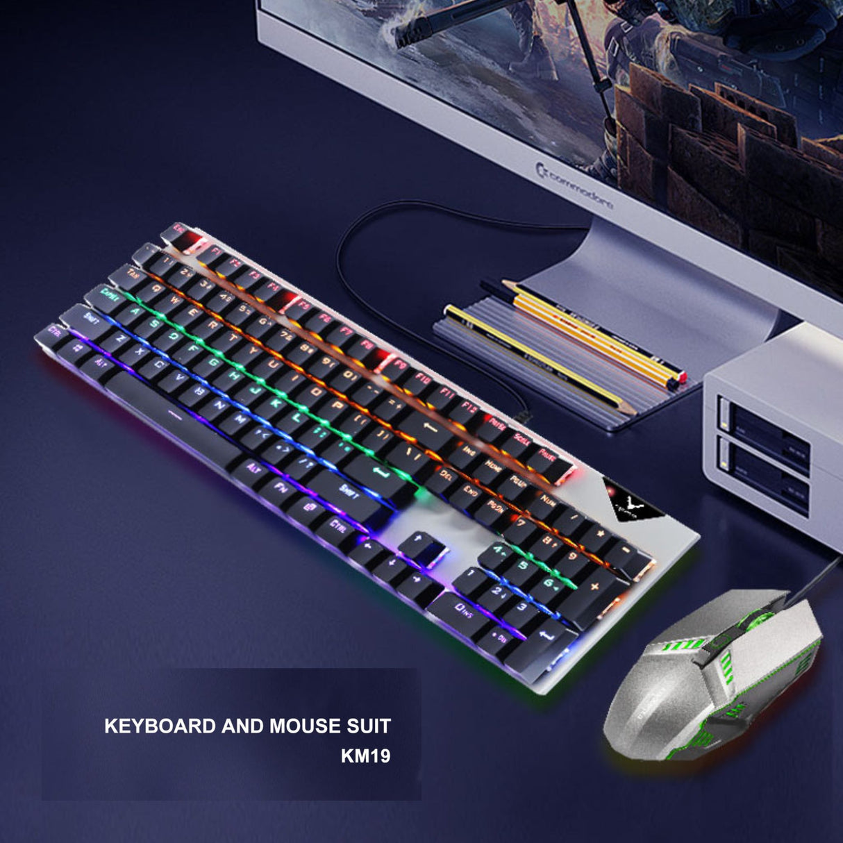 RGB gaming keyboard and mouse set on a desk with monitor. Backlit keyboard enhances gaming setup aesthetics.