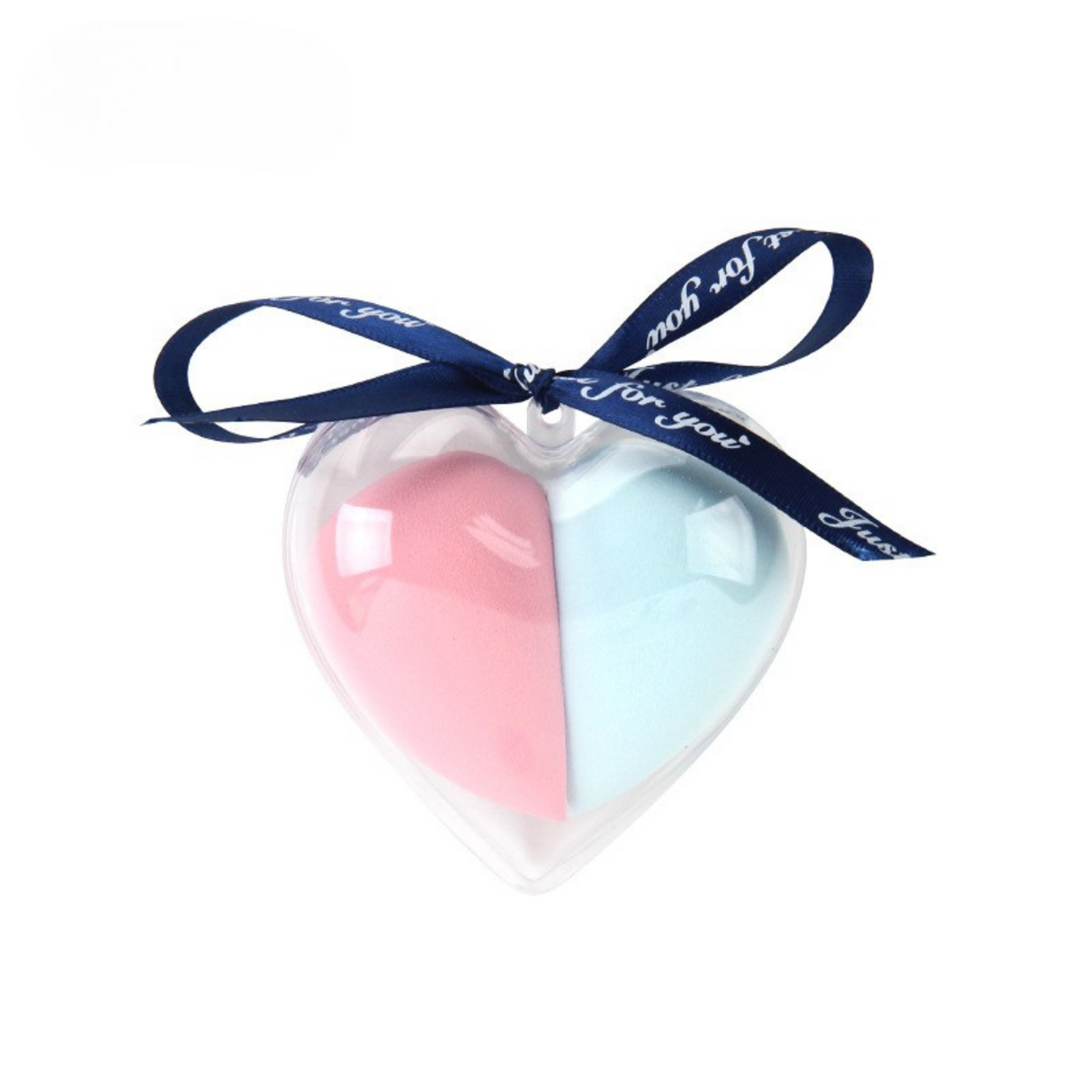 Transparent heart case holding pink and blue makeup sponge with ribbon bow detail.
