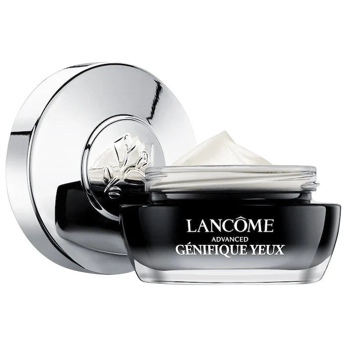 Lancome Advanced Genifique Eye Cream jar with silver lid placed beside it. The product shows a smooth cream texture inside the container.