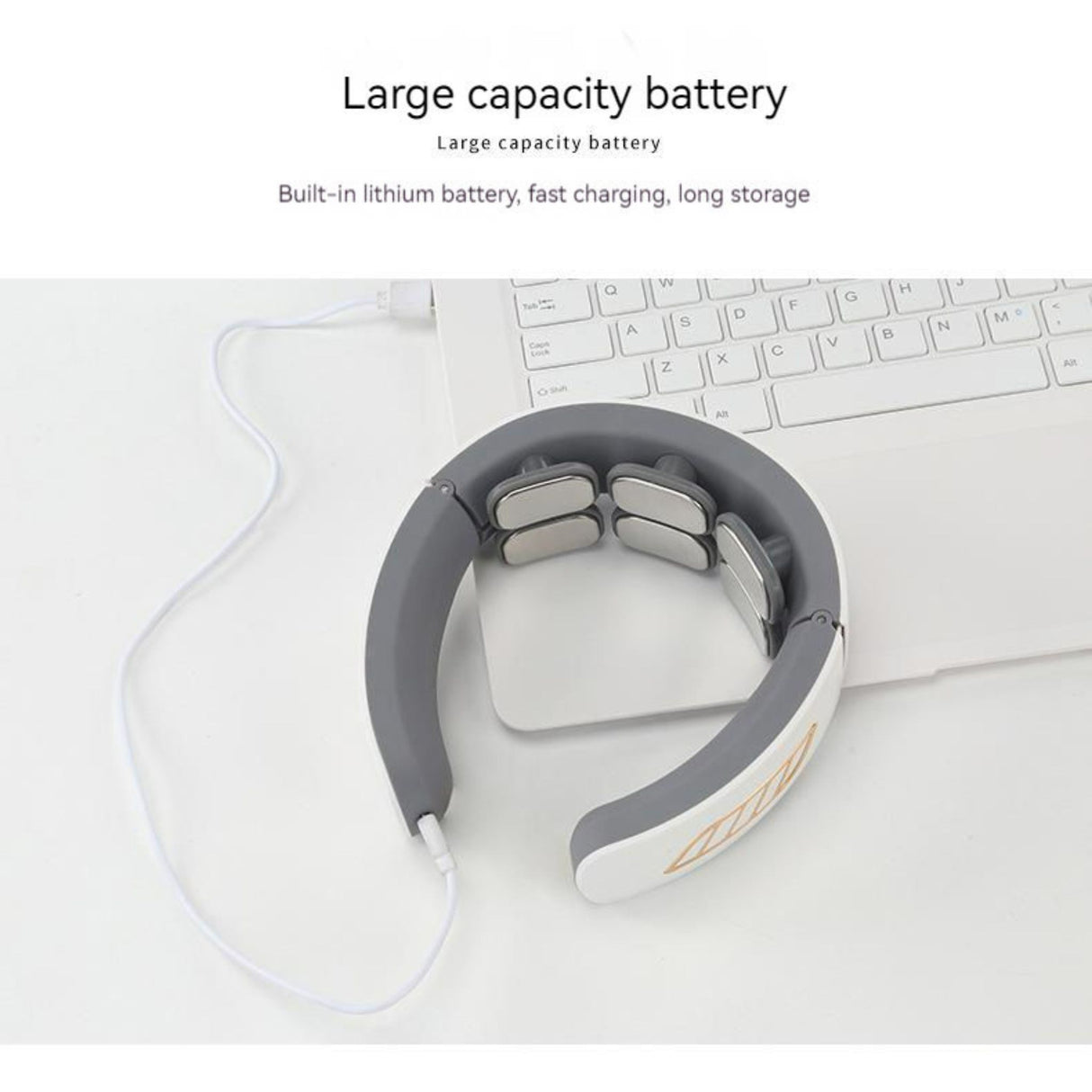 USB rechargeable neck massager charging via cable with large capacity battery. Device placed near laptop showing fast charging capability.