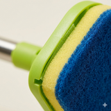 Close-up of scrub brush head showing sponge and bristle attachment detail