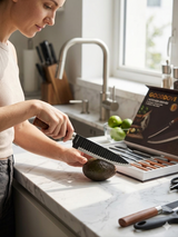 woman slicing avocado using serrated kitchen knife with ergonomic handle