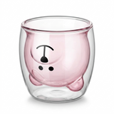 Transparent double wall glass cup showing a pink inner cup with a simple face print. Unique insulated design with a soft rounded form.