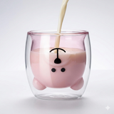 Double wall glass cup being filled with milk, highlighting the pink inner layer and face design. Insulated glass keeps drinks looking stylish and warm.