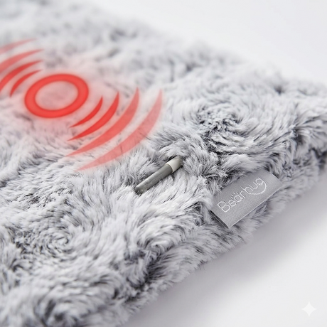 Close-up of Bearhug weighted heating pad showing vibration module and plush fabric detail