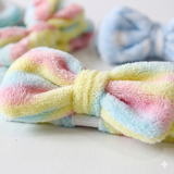 Coral fleece bow headband close-up showing soft plush texture detail