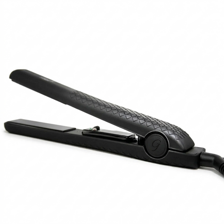 A side-angle shot of the matte black Ginalli Milano Tourmaline Flat Iron against a clean white background, highlighting its ergonomic handle and textured grip.