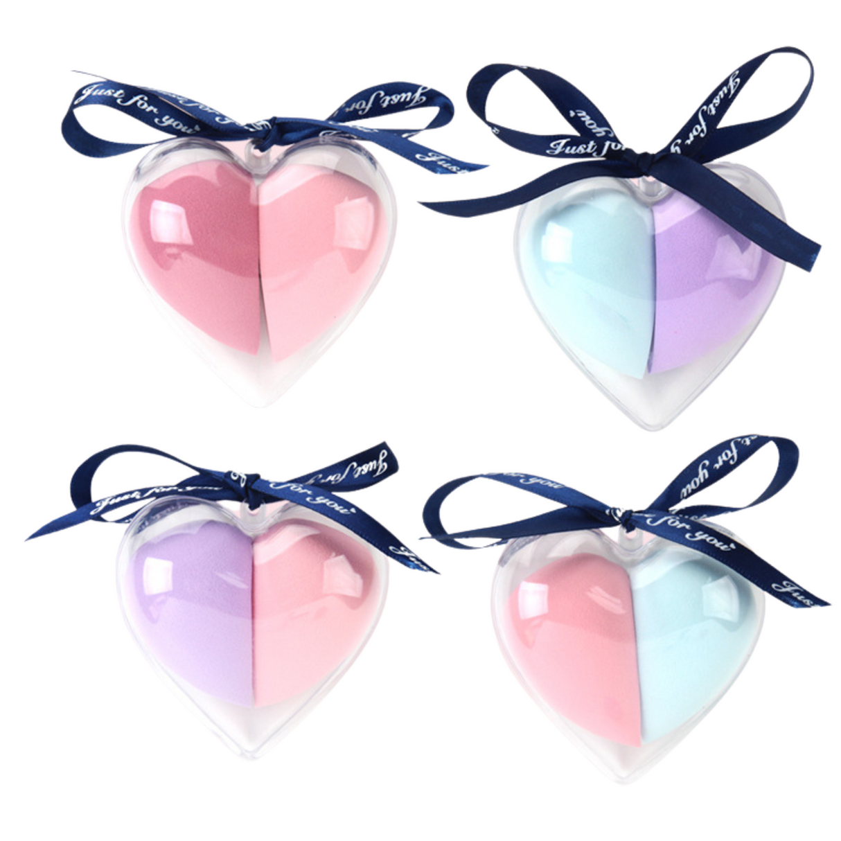 Colorful heart-shaped makeup sponge puffs in transparent case with ribbon for gift-ready presentation.