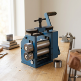 Jewelry rolling mill machine on workbench with hand crank and dual rollers