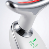 Close-up of the LED neck massager showing the light panel and control indicators. Detailed view of the sleek metallic and plastic finish.
