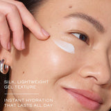 A person applying Lancome Advanced Genifique Eye Cream under the eye area. The lightweight gel texture spreads smoothly on the skin.