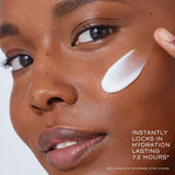 Model applying Lancome Genifique Night Repair Cream on cheek. The product locks in hydration and leaves skin glowing.