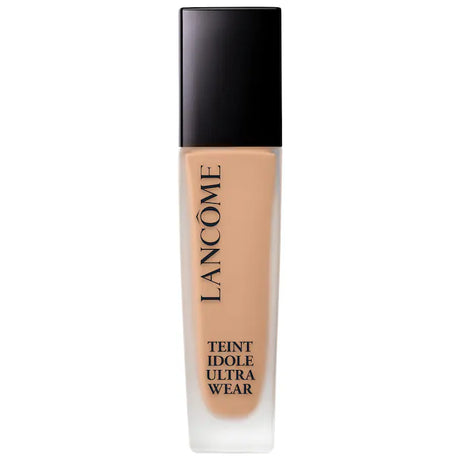 ancome Teint Idole Ultra Wear Foundation bottle with black cap on a plain background. The liquid foundation shade is visible through the glass bottle.