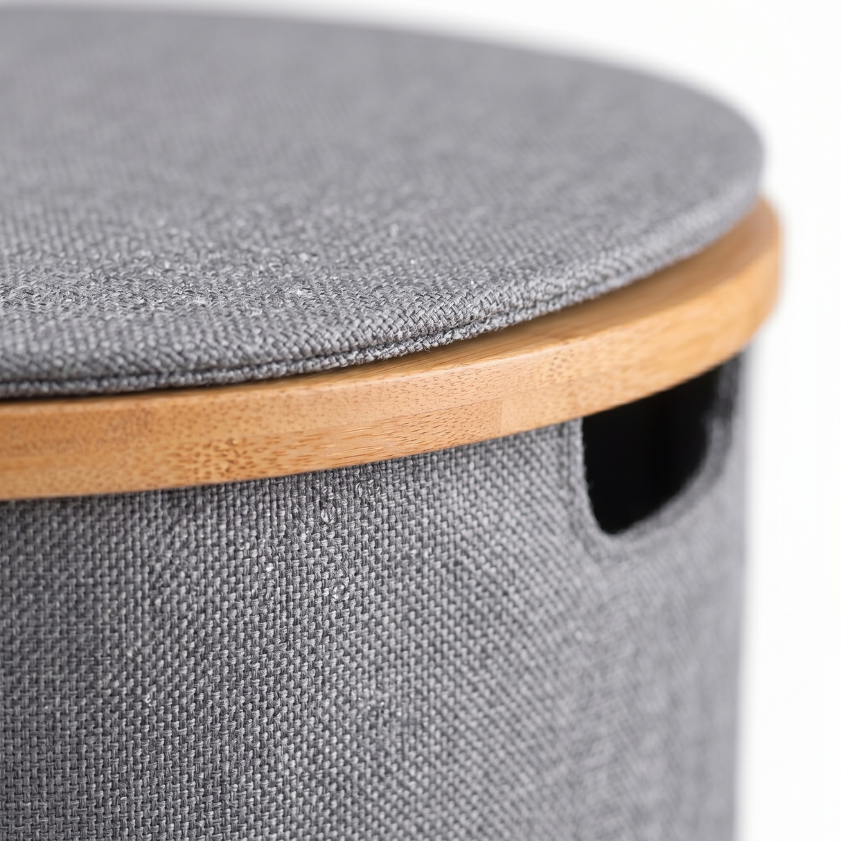 Close-up of laundry hamper lid and bamboo edge detail
