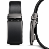 A sleek front and side-profile view of a men's leather ratchet belt featuring a minimalist matte black buckle. The image highlights the slim mechanism and the premium textured finish of the black leather strap.