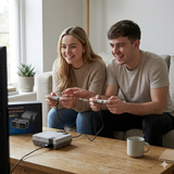 Two people playing mini retro game console with wired controllers at home