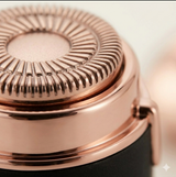 Extreme close-up of the electric facial hair remover blade head. Detailed view of the fine rotary shaving mechanism.
