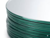 Close-up of stacked round mirror centerpiece trays showing smooth beveled glass edges