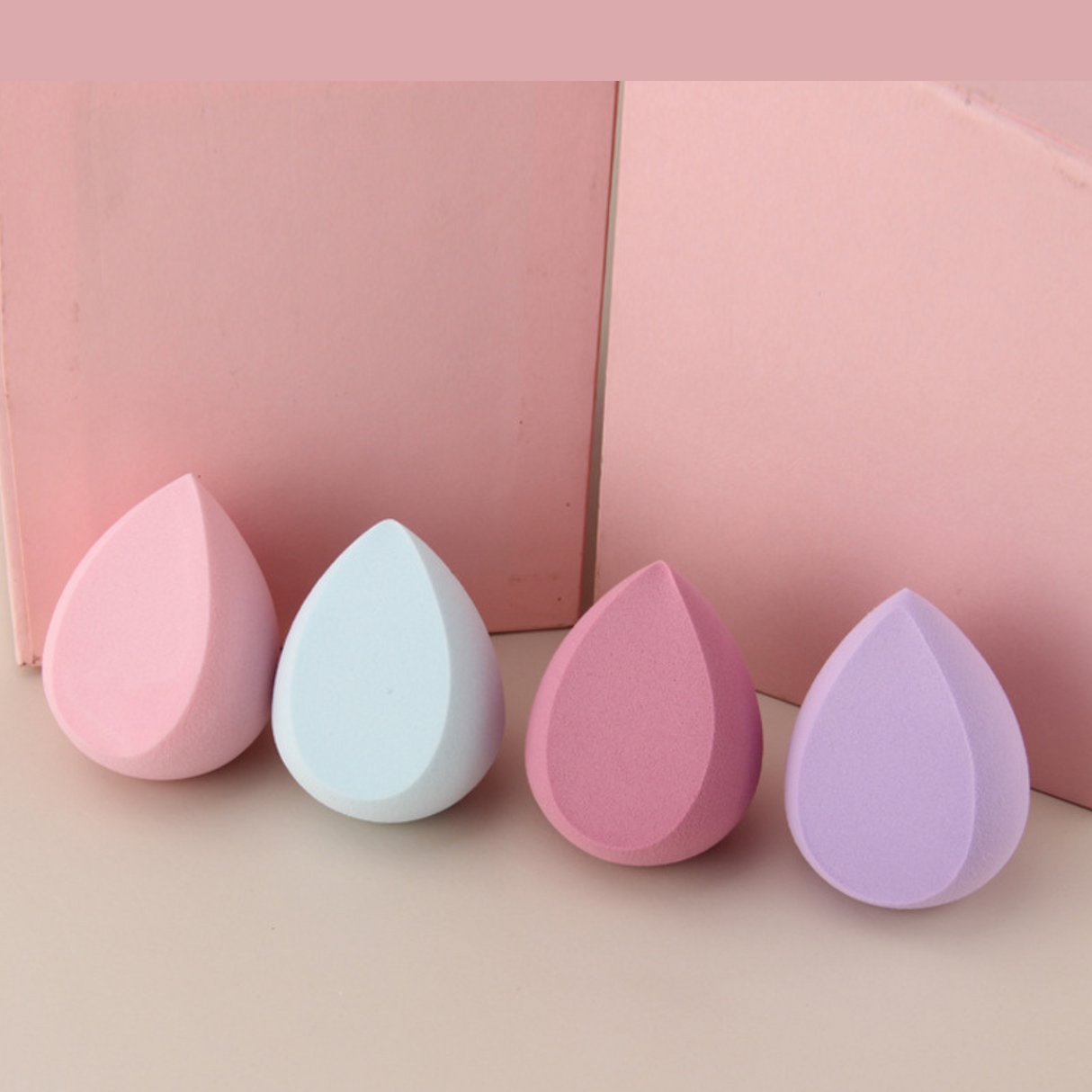 Assorted pastel teardrop makeup sponges designed for flawless foundation and concealer application.