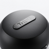 Close-up of the Tribit logo on a black earbud charging case.
