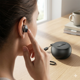 Close-up of a person wearing a small, ergonomic Tribit FlyBuds 1 earbud in her ear, with her finger touching it.