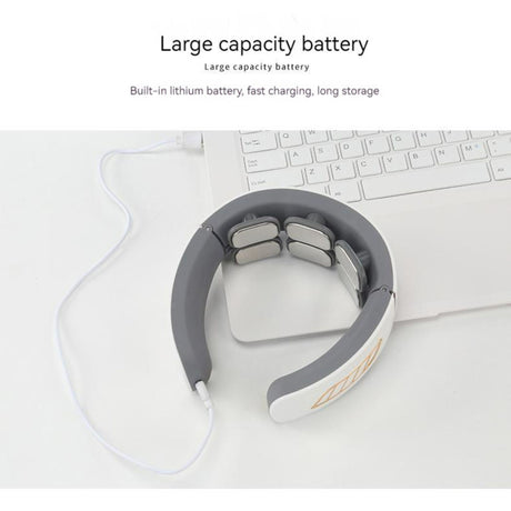 USB rechargeable neck massager charging via cable with large capacity battery. Device placed near laptop showing fast charging capability.