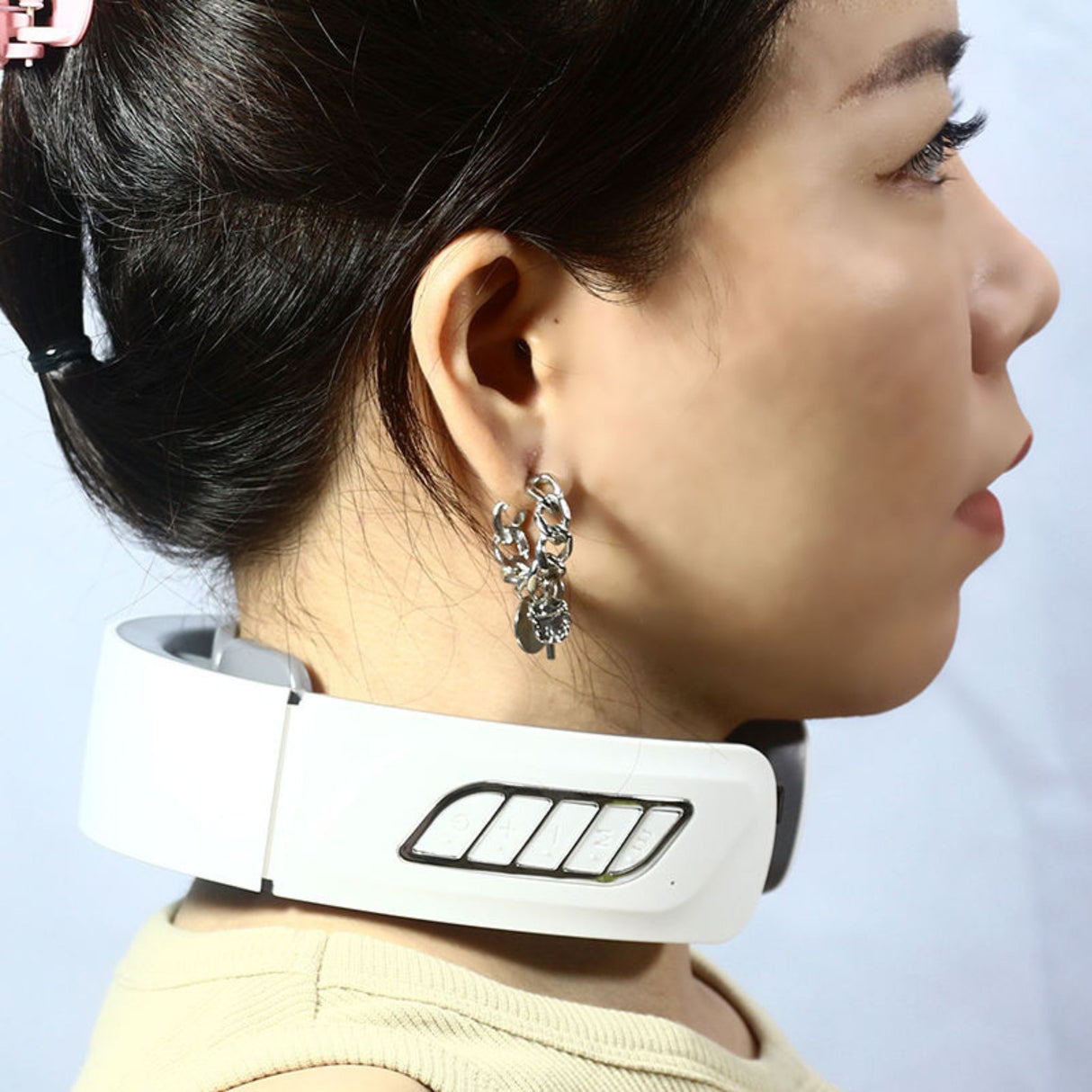 USB rechargeable neck massager worn around neck by user. Hands-free electric massager for relaxation and muscle relief.