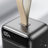 Power bank close-up showing textured strap and battery percentage display