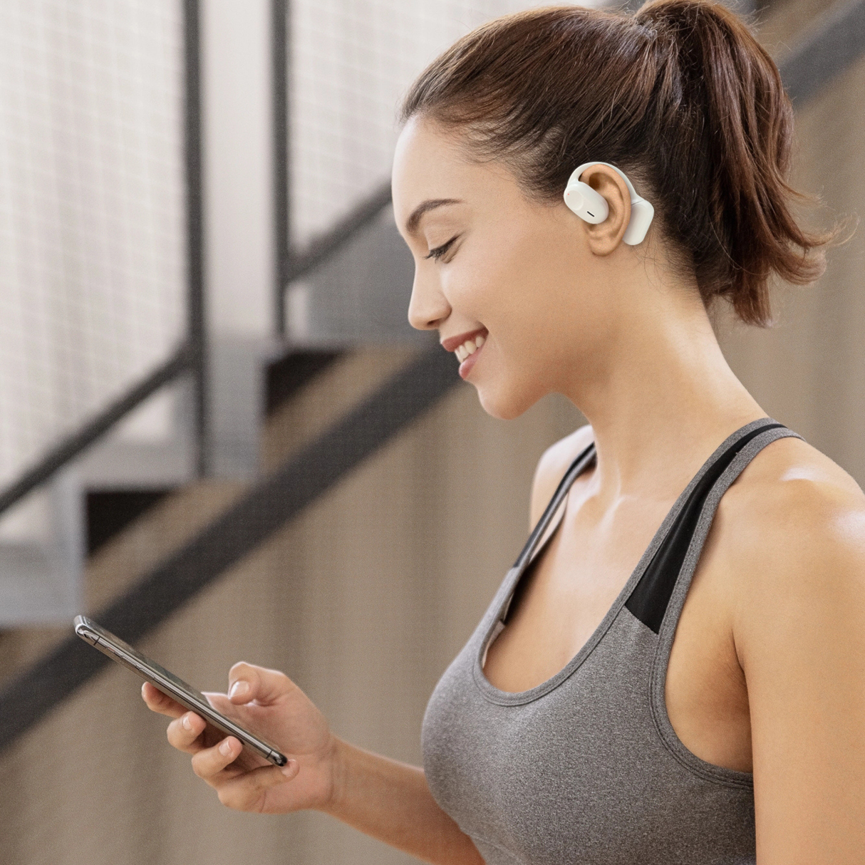 Wesdar TWS516 wireless earbuds worn by a woman during workout. Sport earbuds provide secure fit and hands-free use.