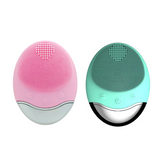 Wireless silicone facial cleansing brush shown in pink and green color options. Compact oval design with soft silicone bristles for gentle face cleaning.