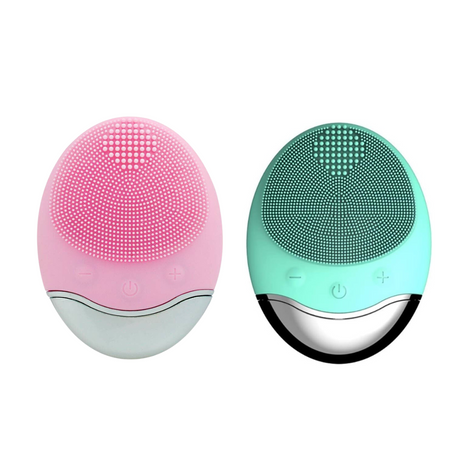 Wireless silicone facial cleansing brush shown in pink and green color options. Compact oval design with soft silicone bristles for gentle face cleaning.